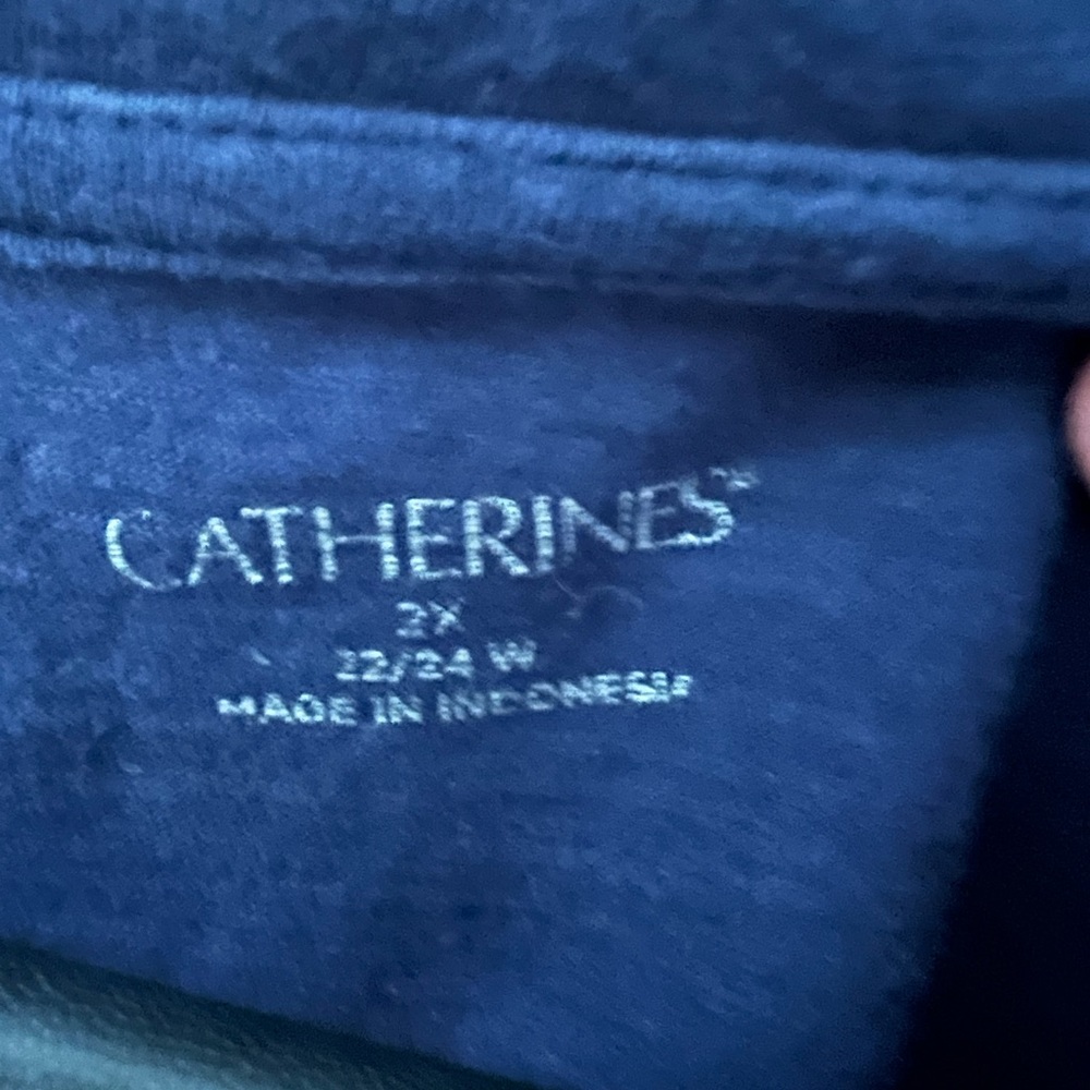Catherine’s navy blue tunic w floral pattern.